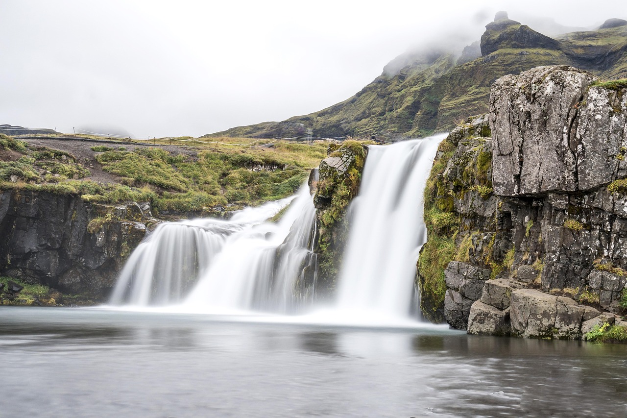 Iceland waterfall and dramatic mountain landscape
