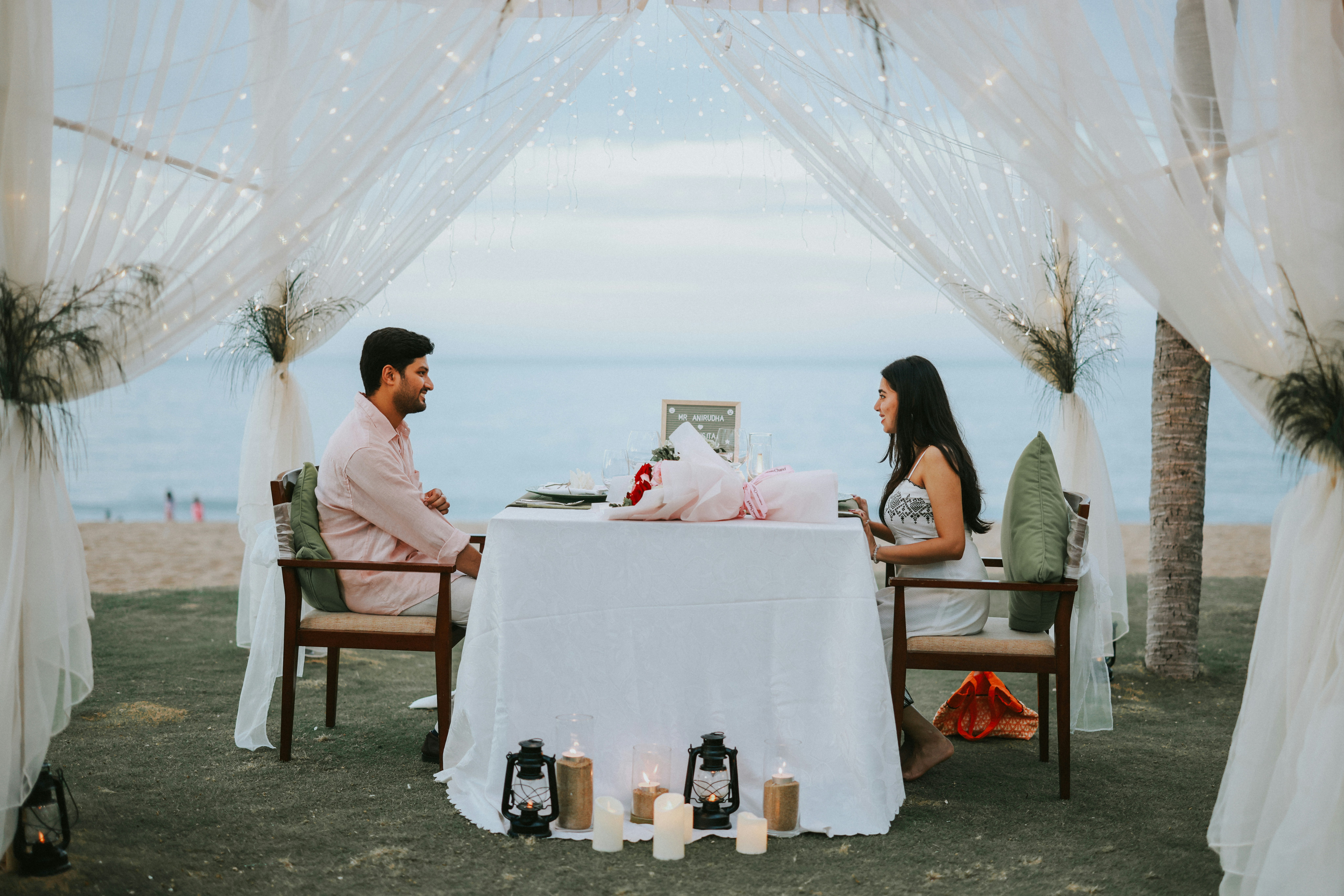 Couple dining together at a romantic beach dinner